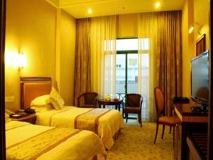 a hotel room with two beds and a television at Quanzhou Royal Prince Hotel in Quanzhou