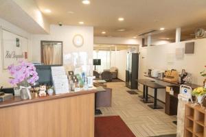 a waiting area of a salon with flowers on a counter at Hotel Bougainvillea Itabashi in Tokyo