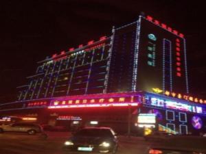 a large building with red and blue lights on it at Aksu Pudong Holiday Hotel in Aksu