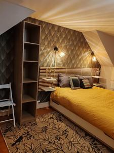a bedroom with a bed and a book shelf at Villa Francette à 500m de la plage in Ouistreham