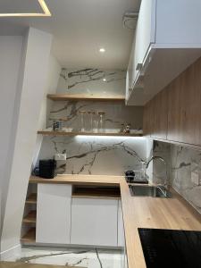 a kitchen with white cabinets and a sink at Appartement Malesherbes Paris in Paris