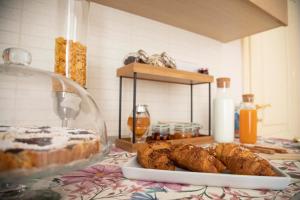 a plate of bread and pastries on a table at Dimora cAmelia in Lucera