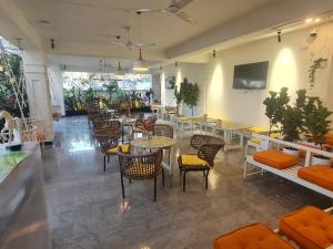 a restaurant with tables and chairs in a room at Embassy Suites in Hyderabad