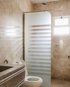 a bathroom with a toilet and a sink and a shower at شاليه رويال الخبر - Royal Resort AL Khobar in Al Khobar