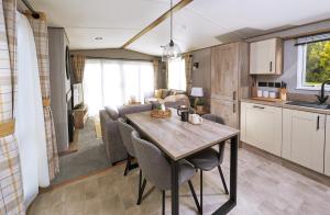 a kitchen and dining room with a table in a room at Ullswater Holiday Park - Static 5 in Penrith