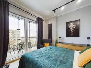 a bedroom with a bed and a large window at Exceptional Business Apartments by Noclegi Renters in Warsaw +94 photos