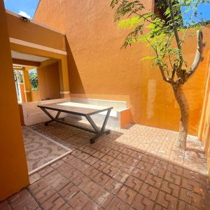 a picnic table sitting outside of a building with a tree at 4BEDROOMS Elegant House For Family & Groups Staycation In Cagayan de Oro City in Cagayan de Oro