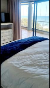 a bedroom with a bed with a view of the ocean at Indigo Bay 29 in Margate