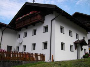 a white building with a balcony with flowers on it at Prantl Roswitha in Sölden