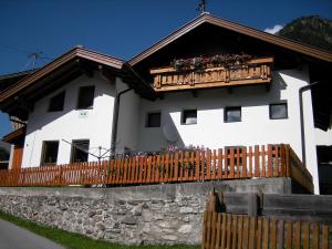 a white house with a balcony with flowers on it at Prantl Roswitha in Sölden