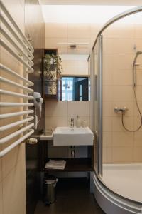 a bathroom with a sink and a shower at Expo Apartments in Poznań