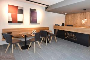 a restaurant with two tables and chairs and a counter at C h illas Appartements in Kappl