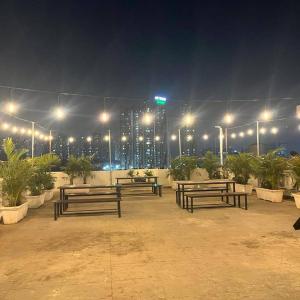 a group of benches in a parking lot at night at Embassy Suites in Hyderabad