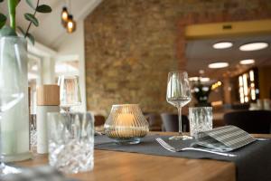 a table in a restaurant with glasses on it at Herrenhaus im Artland in Ankum