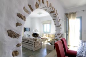 a living room with a stone archway and a living room at Villa St' Astra in Koufonisia