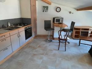 a kitchen with a sink and a table with chairs at Maison de malbrouck in Merschweiller