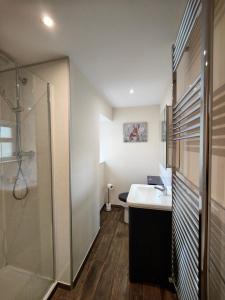 a bathroom with a sink and a shower at Holiday Cottage 4 in Penrith