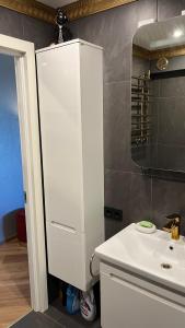 ein weißes Badezimmer mit einem Waschbecken und einem Spiegel in der Unterkunft Last Floor Apartments in Narva-Jõesuu