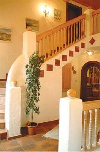 a staircase in a house with a potted plant at Appartements Wörgötter Astrid & Sepp in Rettenbach