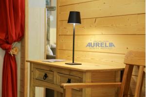 a lamp sitting on a table in a room at Hôtel Aurélia in Saint-Lary-Soulan +56 photos