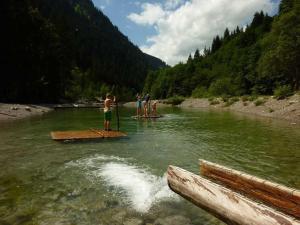 a group of people standing on a raft in a river at Haus Häsischa - Biobauernhof im Biosphaerenpark - in Marul