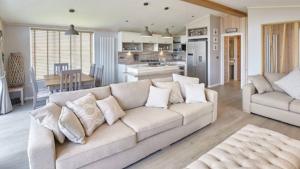 a living room with a couch and a kitchen at Stunning Lodge at Runswick Bay - Dog Friendly in Runswick