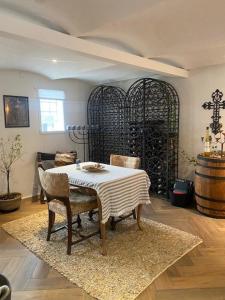 a dining room with a table and chairs and a wine cellar at Guldforhoved B&B 