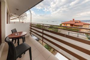 balcón con mesa, sillas y vistas al océano en Apartma Gaja, en Koper