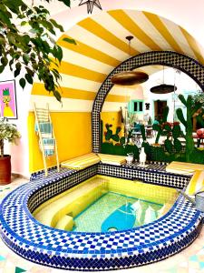 a swimming pool in a house with a tile floor at Riad Lauriers Blancs in Marrakesh