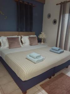 two beds in a bedroom with towels on them at Kissamos sea view beach apartments in Kissamos