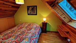 a bedroom with a large bed and a window at Menez Triaou - Maison avec grand jardin in Plomodiern