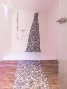 a shower in a bathroom with a shower curtain at Appartementresidenz 4 Seasons in Timmendorfer Strand