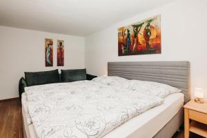 a bedroom with a large white bed in it at Rosi's Appartement in Grossarl