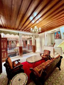 a living room with a couch and chairs and a table at Riad el wazania in Rabat