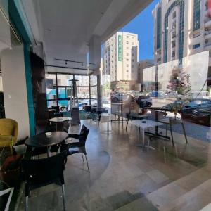 a restaurant with tables and chairs and a view of a city at City View, Ennasr Spacious s2 Apartment in Ariana