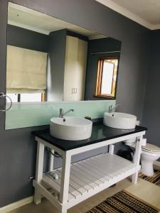 a bathroom with two sinks and a mirror at Bella Hideaway in East London