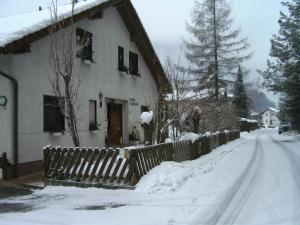 a house with a fence in the snow at Apart Haus Florian in Imst