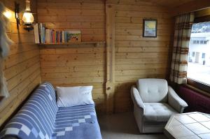 a bedroom with a bed and a chair and a window at Schweizerhof 