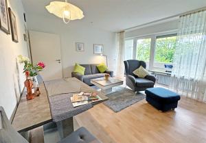 a living room with a couch and a table at Apartment am Kurpark in Bad Krozingen