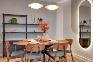 a dining room with a wooden table and chairs at Nadmotławie Riverside - Gym & Free Parking by Downtown Apartments in Gdańsk