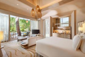 a bedroom with a white bed and a living room at BIJAL in Side