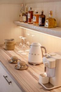 a kitchen counter with a tea kettle and glasses at BIJAL in Side