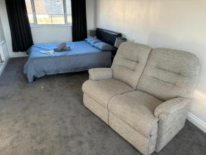 a living room with a couch and a bed at Nanny and Chips House in Whitby