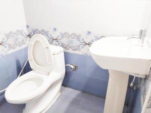 a bathroom with a toilet and a sink at dreams cottage in Ooty