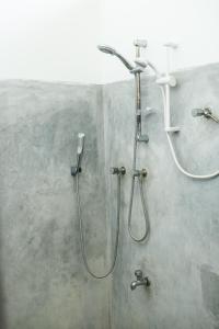 a shower in a bathroom with a shower head at Relax Beach House in Tangalle +99 photos