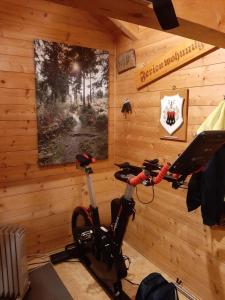 a bike is parked in a room with wooden walls at Ferienwohnungen im Griachalgarten - Chiemgau Karte in Inzell