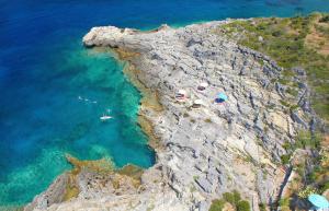 an aerial view of a cliff with boats in the water at Mani Suites luxury seaside accommodation in Agios Nikolaos