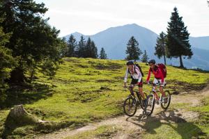 two people riding bikes on a dirt trail at Chalets Grossmitt in Pertisau