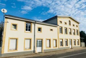 a large white building with a black roof at Maison de malbrouck in Merschweiller