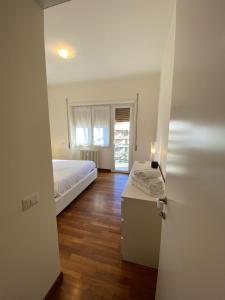 a bedroom with a bed and a table and a window at Diamond Apartment in Rome